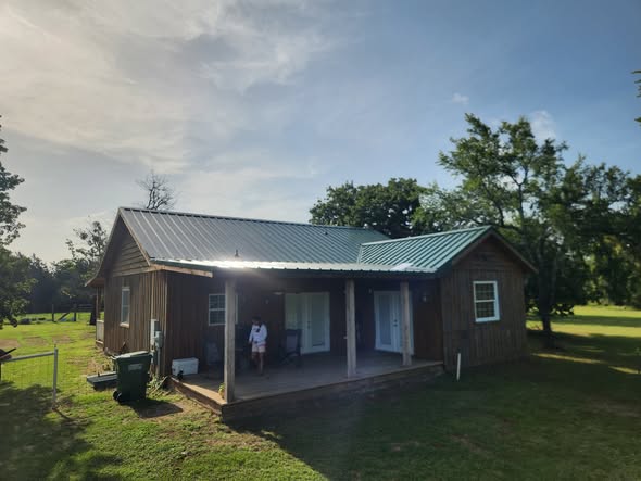 Rustic cabin with a new green metal roof